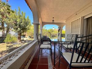a porch with a table and chairs on it at Casa Mar in Valencia