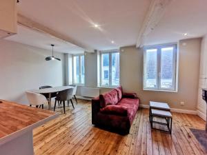 a living room with a couch and a table at Premium Appartement Hesdin in Hesdin