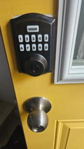 a button on a door with agets at Queen City Comfort in Regina +5 photos