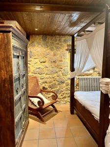 a bedroom with a bed and a rocking chair at La casa de Chipi Lacavada in La Cavada