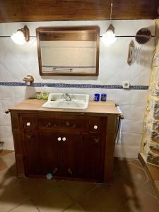 a bathroom with a sink and a mirror at La casa de Chipi Lacavada in La Cavada