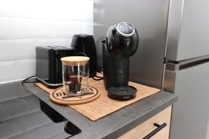 a coffee maker on a counter in a kitchen at La Cosy House in Courcouronnes +13 photos