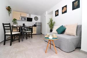 a living room with a couch and a table at La Cosy House in Courcouronnes