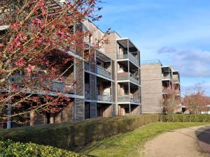 an apartment building with balconies on the side of it at Parenthèse lumineuse près de Disney, Parking privé in Montévrain
