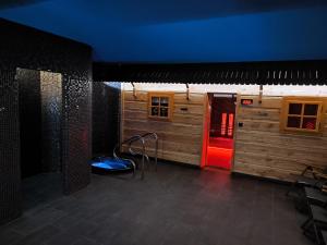 a room with a blue ceiling and a red door at Liptovský mlyn in Bešeňová