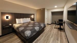 a bedroom with a bed and a flat screen tv at Star Inn & Suites in Chicago Heights