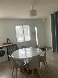 a dining room table and chairs in a kitchen at Petite maison calme in Dun-sur-Auron +2 photos