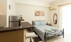 a small kitchen with a bed in a room at Central Cozy Apartment 2 in Sparta