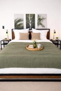 a bedroom with a large bed with a tray on it at N&N Apartments - Studio mit Netflix - Workstation im Zentrum in Schwerin