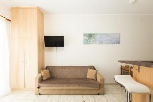 a living room with a couch and a tv at Central Cozy Apartment 2 in Sparta