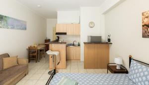a living room with a couch and a kitchen at Central Cozy Apartment 2 in Sparta