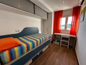 a small bedroom with a bunk bed and a desk at TuttiFruttiaApt in Nerja