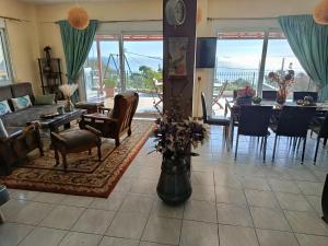 a living room with a couch and chairs and a table at Thalassa in Panayía