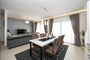 a living room with a dining table and a couch at Villa Olive Tree in Vinišće