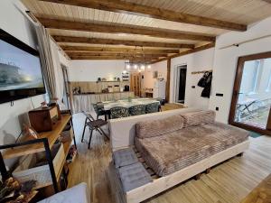 a living room with a bed and a dining room at Casa Delia in Balta