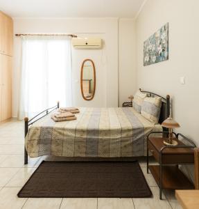 a bedroom with a bed and a mirror at Central Cozy Apartment in Sparta