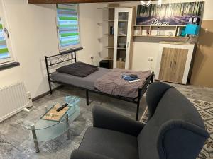 a living room with a bed and a couch at Neu! Einfaches Zimmer - einfacher Preis in Lohra, Hessen - low Budget - für Vertreter - Monteure - Wanderer - Radler - nur WC mit Waschbecken ohne Dusche aber günstig in Lohra
