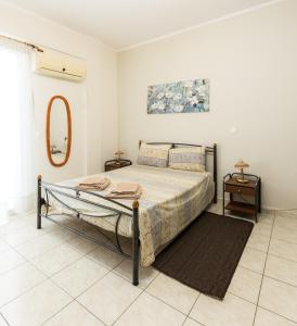 a bedroom with a bed and a mirror at Central Cozy Apartment in Sparta