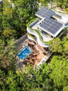 an overhead view of a house with solar panels on the roof at Luxury 4BR Eco Villa 10ppl Outdoor Pizza Oven - Private Pool & Jacuzzi in Tulum