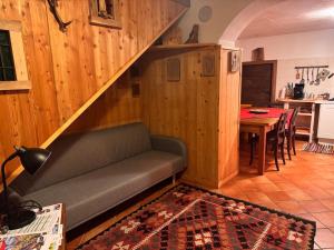 a living room with a couch and a staircase at Cà de l'Angel in Torre di Santa Maria