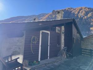 a cabin with a door and a bench on the porch at Cà de l'Angel in Torre di Santa Maria +11 photos