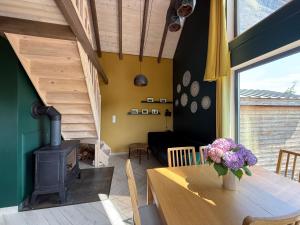 a living room with a table and a wood stove at Siedlisko Święty Spokój in Krzeszowice