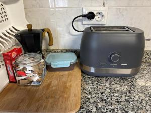 a toaster on a cutting board on a kitchen counter at Norte Astur in Langreo +9 photos