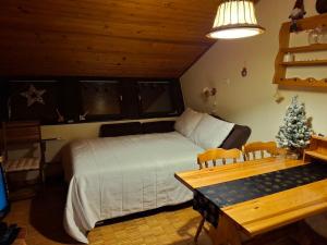 a bedroom with a bed and a christmas tree in it at Cosy Rogla appartment 108 in Zreče