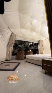 a bedroom with a bed in a tent at Hkaya Rum camp in Disah