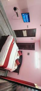 a bedroom with a bed and a tv on the wall at Spk grand hotel in Rushikonda