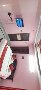 a room with a bed and a tv on the ceiling at Spk grand hotel in Rushikonda