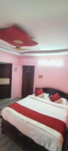 a bedroom with a large bed with a ceiling at Spk grand hotel in Rushikonda