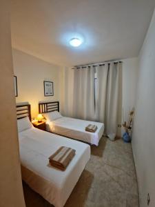 two beds in a room with two beds sidx sidx sidx sidx at Apartamentos Residencial Duquesa in San Luis de Sabinillas