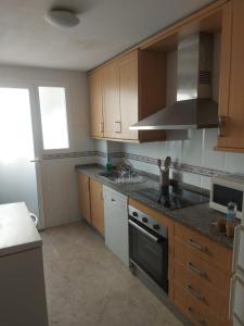 a kitchen with a sink and a stove top oven at Apartamentos Residencial Duquesa in San Luis de Sabinillas +12 photos