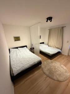 a bedroom with two beds and a rug at Ferienhaus Arlewatt in Arlewatt