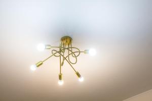 a chandelier hanging from a ceiling at Central Cozy Apartment 4 in Sparta +6 photos