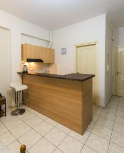 a kitchen with a wooden counter top in a room at Central Cozy Apartment 4 in Sparta