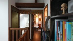 a hallway with a staircase and a room with books at Maison Cozy Deco P0P' proche Paris in Villejust