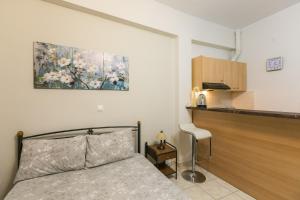 a bedroom with a bed and a table and a kitchen at Central Cozy Apartment 4 in Sparta