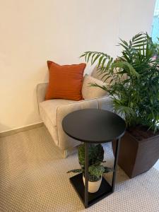 a coffee table in front of a couch with plants at Hotel LUMIè Pescasseroli in Pescasseroli