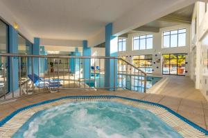 a large pool in the middle of a building at Sea House Apartment - Private Condo with 4 Pools, Jacuzzi & Tennis Court in Albufeira