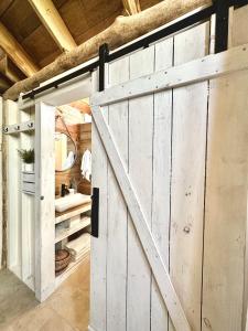 a sliding barn door in a bathroom with a sink at Shipwreck Cove in Caye Caulker