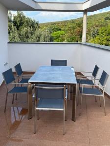 a blue table and chairs on a balcony at Marina Penthouse in Punat +18 photos