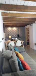 a living room with a couch with pillows on it at La petite romantique in Martelange