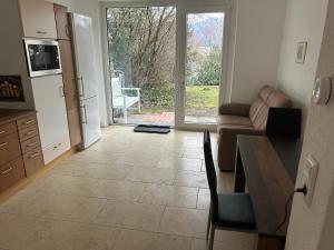 a living room with a kitchen with a table and a couch at Garten Wohnung in Singen +10 photos