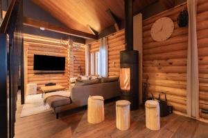 a living room with a couch and a clock on the wall at Levillenet Bearlodge at Levi city centre in Levi