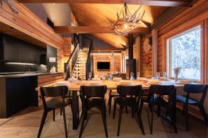 a dining room with a large wooden table and chairs at Levillenet Bearlodge at Levi city centre in Levi
