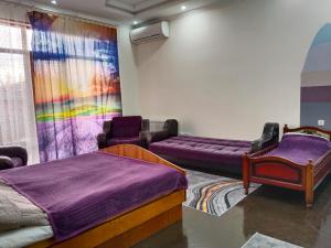 a room with two beds and a couch at Vanilla Mountains in Kutaisi