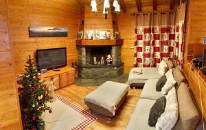 a living room with a christmas tree and a fireplace at Les Bosquitos Chalet in Ax-les-Thermes
