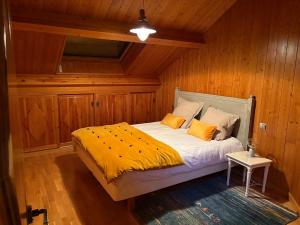 a bedroom with a bed in a wooden room at Les Bosquitos Chalet in Ax-les-Thermes